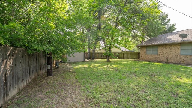 view of yard featuring a storage unit and an outbuilding