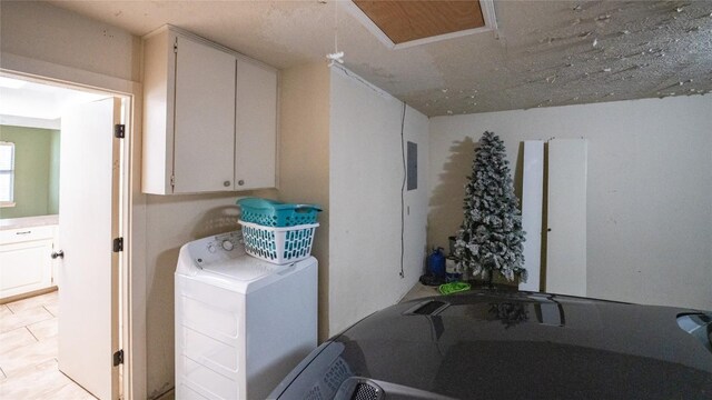 washroom featuring cabinet space and washer / clothes dryer