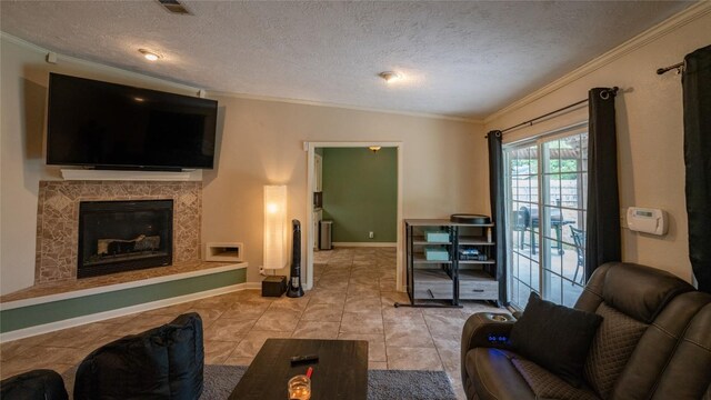 living room featuring ornamental molding, a textured ceiling, a fireplace, light tile patterned flooring, and baseboards