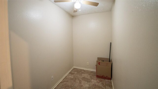 unfurnished room with a ceiling fan and baseboards