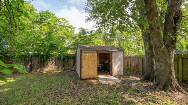 view of shed with a fenced backyard
