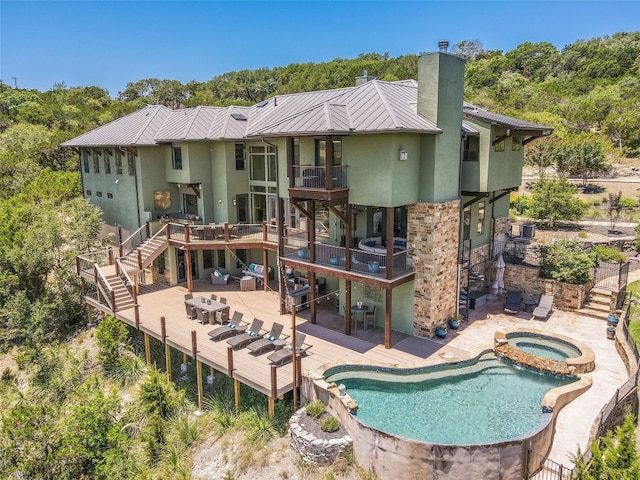 400 Hillview Rd, Wimberley, TX 78676 - back of house featuring stairs, stucco siding, a chimney, and metal roof