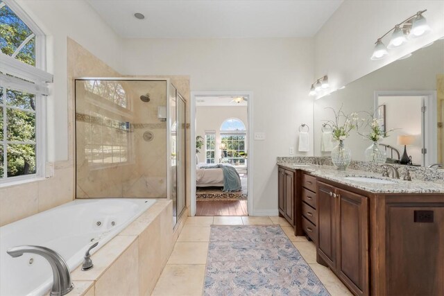 1016 High Hill Creek Rd, La Grange, TX 78945 - ensuite bathroom featuring a jetted tub, a shower stall, double vanity, and tile patterned flooring