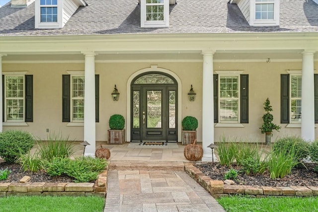 1016 High Hill Creek Rd, La Grange, TX 78945 - property entrance with a porch, stucco siding, and roof with shingles