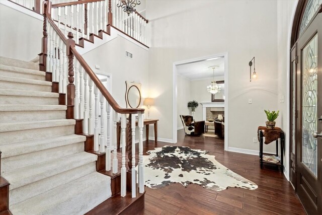 1016 High Hill Creek Rd, La Grange, TX 78945 - entryway featuring a towering ceiling, stairway, baseboards, wood finished floors, and a chandelier