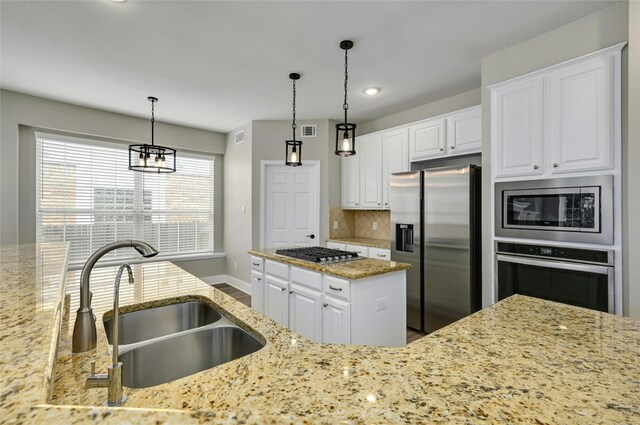 4933 China Garden Dr, Austin, TX 78730 - kitchen with appliances with stainless steel finishes, a sink, light stone countertops, tasteful backsplash, and white cabinets