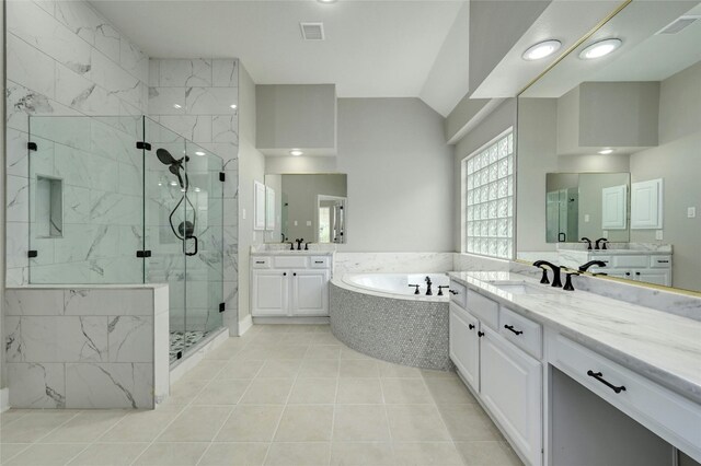 4933 China Garden Dr, Austin, TX 78730 - bathroom with a stall shower, a bath, two vanities, tile patterned flooring, and vaulted ceiling