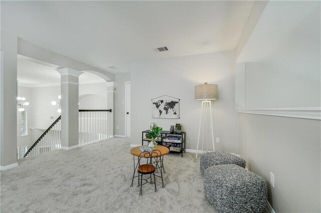 4933 China Garden Dr, Austin, TX 78730 - sitting room with an upstairs landing, carpet, ornate columns, baseboards, and arched walkways