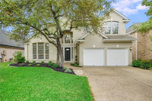 4933 China Garden Dr, Austin, TX 78730 - traditional-style home featuring concrete driveway, a garage, a front yard, and brick siding