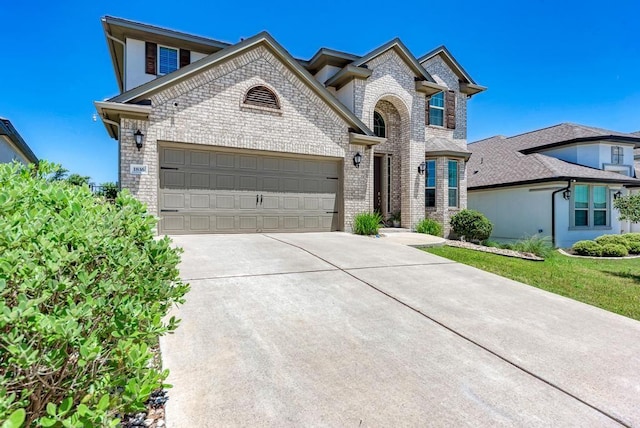1816 Ficuzza Way, Leander, TX 78641 - view of front of home featuring driveway, a garage, and brick siding