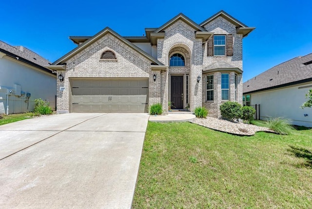 1816 Ficuzza Way, Leander, TX 78641 - view of front facade featuring brick siding, concrete driveway, an attached garage, and a front lawn