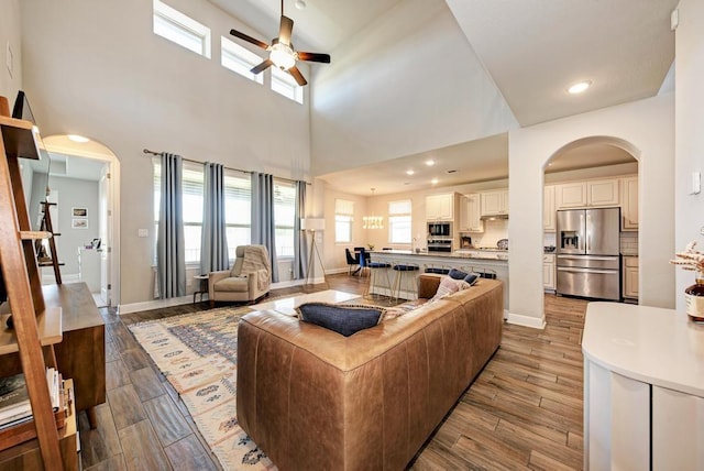1816 Ficuzza Way, Leander, TX 78641 - living area featuring arched walkways, ceiling fan, healthy amount of natural light, a high ceiling, and recessed lighting