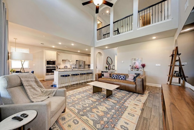 1816 Ficuzza Way, Leander, TX 78641 - living area with light wood-style flooring, ceiling fan, recessed lighting, and a towering ceiling