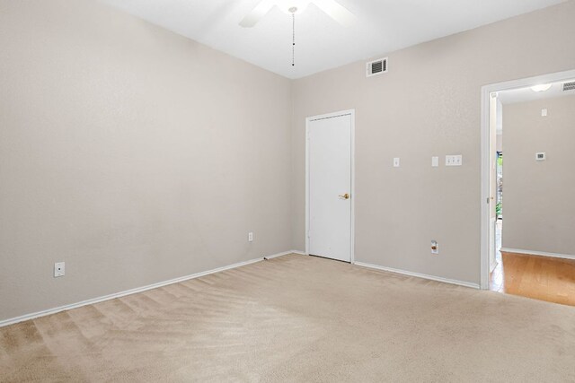 empty room with light carpet, ceiling fan, and baseboards
