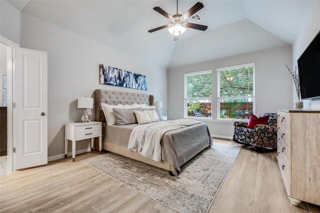 bedroom featuring light wood-type flooring, lofted ceiling, ceiling fan, and baseboards