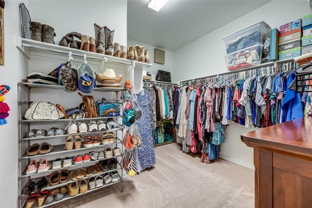 walk in closet featuring carpet flooring