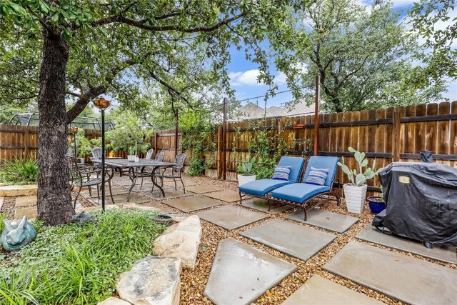 view of patio featuring a fenced backyard and a grill