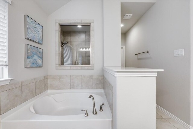 full bathroom featuring a garden tub, a tile shower, and tile patterned flooring