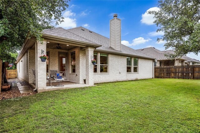 back of property featuring a chimney, a patio area, a ceiling fan, and brick siding