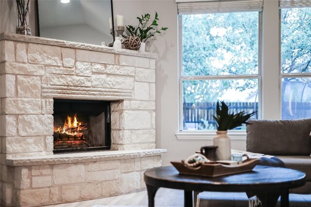 living room with a stone fireplace