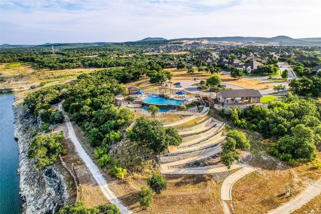 bird's eye view of a pool and a water and mountain view