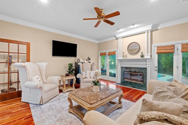 8900 Bell Mountain Dr, Austin, TX 78730 - living area with wood finished floors, crown molding, a ceiling fan, and a premium fireplace