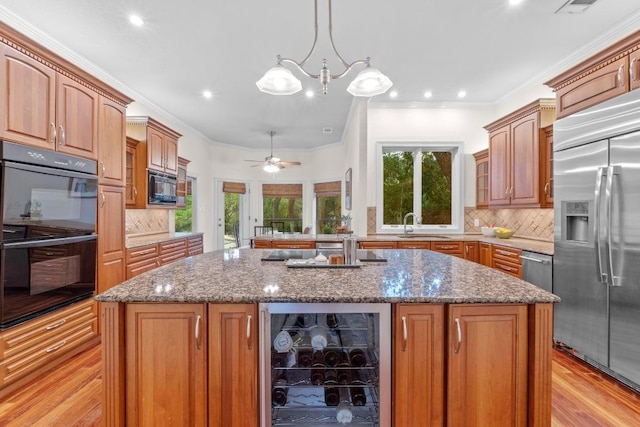 8900 Bell Mountain Dr, Austin, TX 78730 - kitchen with black appliances, beverage cooler, a center island, decorative backsplash, and crown molding
