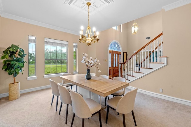 carpeted dining room with a chandelier, plenty of natural light, baseboards, crown molding, and stairway