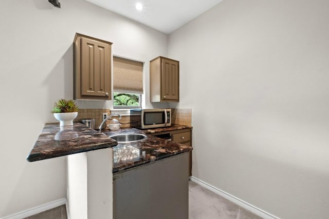 8900 Bell Mountain Dr, Austin, TX 78730 - kitchen with stainless steel microwave, light colored carpet, and decorative backsplash