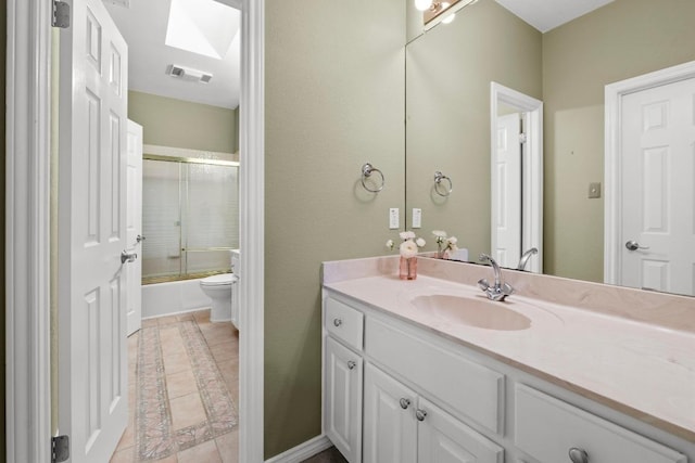 8900 Bell Mountain Dr, Austin, TX 78730 - full bathroom featuring vanity, a skylight, bath / shower combo with glass door, and tile patterned floors