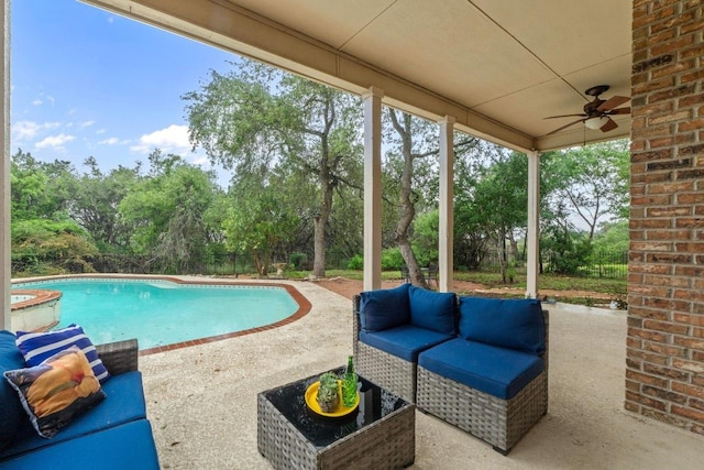 outdoor pool featuring an outdoor living space, a patio area, ceiling fan, and view of scattered trees
