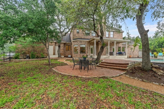 8900 Bell Mountain Dr, Austin, TX 78730 - rear view of property featuring brick siding and a patio area