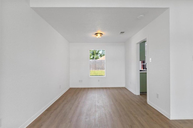 2310 Raintree Path, Round Rock, TX 78664 - empty room featuring wood finished floors and baseboards