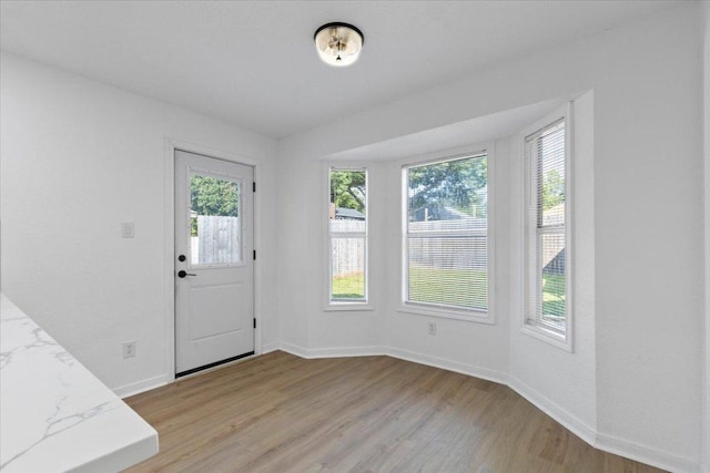 2310 Raintree Path, Round Rock, TX 78664 - unfurnished dining area with light wood finished floors and baseboards