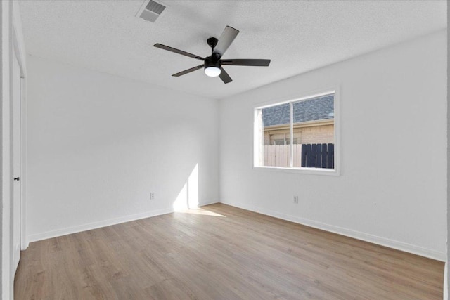 2310 Raintree Path, Round Rock, TX 78664 - empty room featuring wood finished floors, a textured ceiling, and a ceiling fan