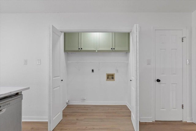 2310 Raintree Path, Round Rock, TX 78664 - laundry area with cabinet space, hookup for an electric dryer, light wood-type flooring, and hookup for a washing machine
