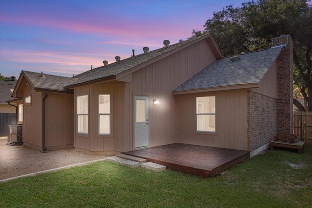 2310 Raintree Path, Round Rock, TX 78664 - back of house at dusk with a wooden deck and roof with shingles