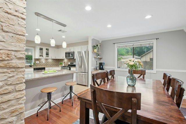 2627 Oak Meadow Dr, Round Rock, TX 78681 - dining area with light wood-type flooring, recessed lighting, and ornamental molding
