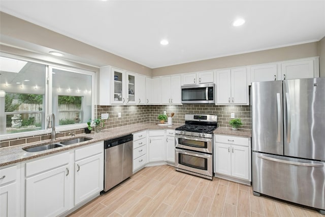 2627 Oak Meadow Dr, Round Rock, TX 78681 - kitchen featuring stainless steel appliances, a sink, backsplash, white cabinetry, and recessed lighting