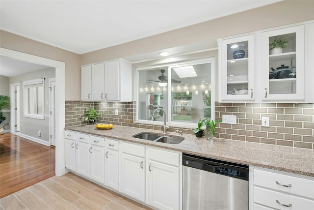 2627 Oak Meadow Dr, Round Rock, TX 78681 - kitchen featuring dishwasher, a sink, light stone countertops, and white cabinets