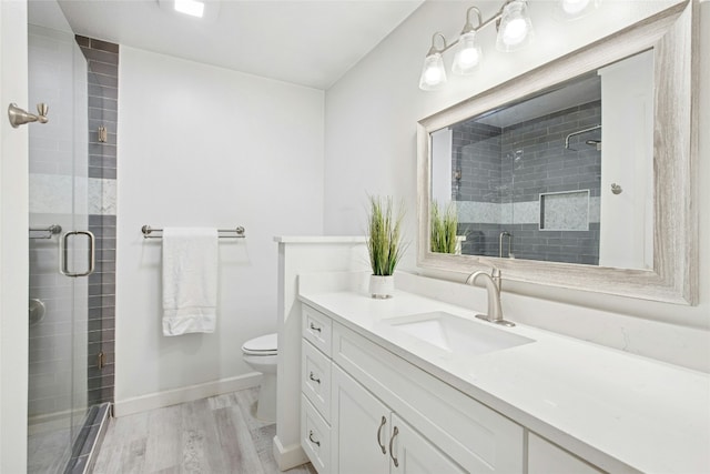 2627 Oak Meadow Dr, Round Rock, TX 78681 - full bathroom with wood finished floors, a shower stall, toilet, vanity, and baseboards