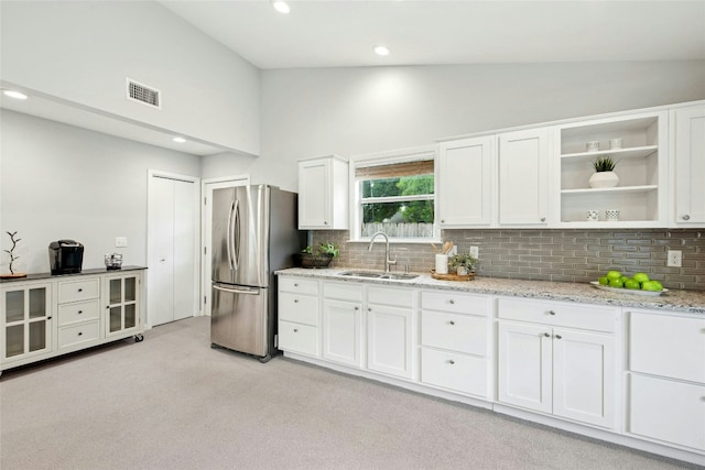 2627 Oak Meadow Dr, Round Rock, TX 78681 - kitchen with a sink, freestanding refrigerator, tasteful backsplash, light carpet, and high vaulted ceiling