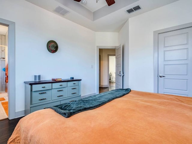 604 Allen St Unit 103, Austin, TX 78702 - bedroom featuring dark wood finished floors, baseboards, a ceiling fan, and connected bathroom