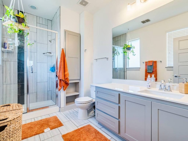 604 Allen St Unit 103, Austin, TX 78702 - bathroom with a shower stall, toilet, vanity, and tile patterned flooring