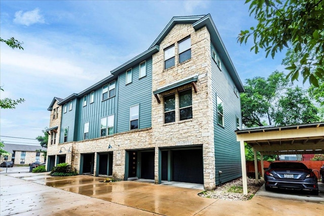 604 Allen St Unit 103, Austin, TX 78702 - view of front of home featuring stone siding and driveway