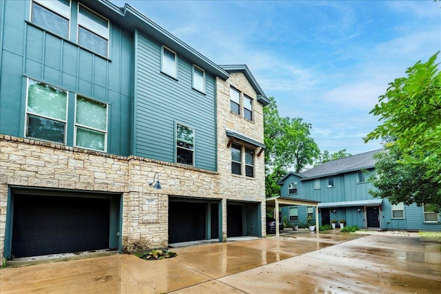 604 Allen St Unit 103, Austin, TX 78702 - view of building exterior with a garage and driveway