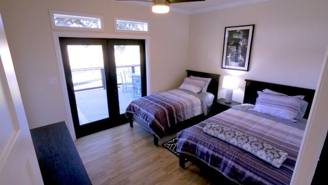 bedroom featuring french doors, light wood-type flooring, crown molding, and a ceiling fan