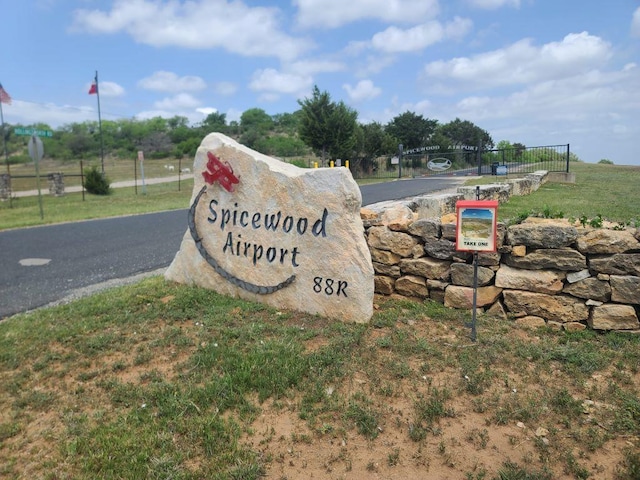community sign featuring fence