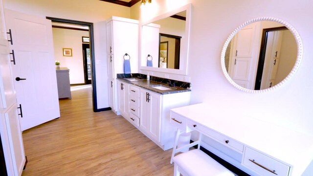 bathroom featuring wood finished floors and vanity