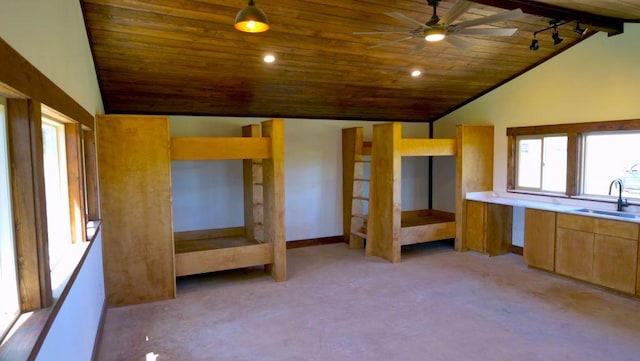kitchen featuring lofted ceiling, wooden ceiling, a sink, light colored carpet, and ceiling fan